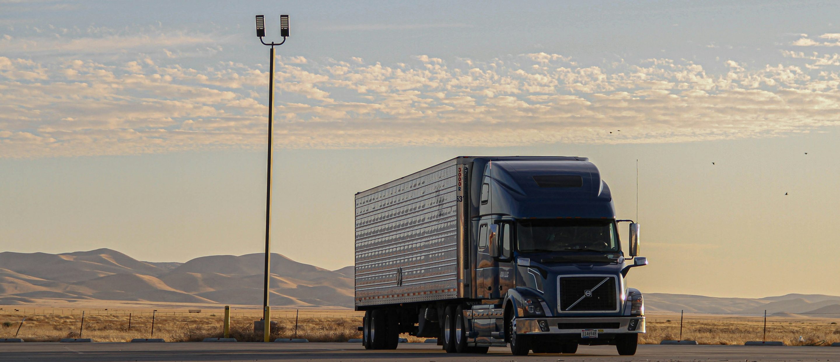 Owner operator semi truck on the highway at sunrise